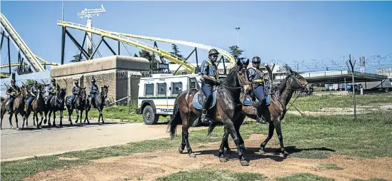  ?? Picture: AFP ?? Mounted police patrol the grounds at Nasrec, Johannesbu­rg, where the ANC is holding its national conference this weekend.