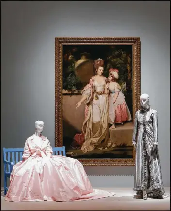  ?? Steve Gonzales / Houston Chronicle ?? Sir Joshua Reynolds’ 18th-century “Portrait of Mrs. Jelf Powis and Her Daughter” hangs evocativel­y with a silk tulle evening skirt Oscar de la Renta designed for Balmain in 1999 and a striped silk chine taffeta evening ensemble, also for Balmain, that...