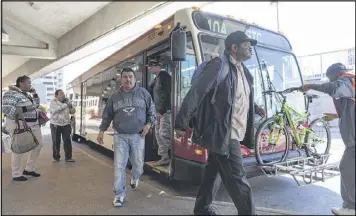  ?? DAVID BARNES / DAVID.BARNES@AJC.COM ?? Passengers exit a bus at the Doraville MARTA Station on Friday. A bridge on I-85 northbound collapsed after a massive fire Thursday night. Many commuters are taking to MARTA to counter road closures.