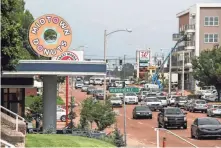  ??  ?? Midtown Donuts sits at 1776 Union, left, as well as The Citizen apartments at 1835 Union, right and pictured at top, as afternoon traffic moves along on July 10. PHOTOS BY BRAD VEST/THE COMMERCIAL APPEAL