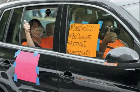  ?? THE ASSOCIATED PRESS ?? Motorists take part in a caravan protest in front of Senator John Kennedy’s office at the Hale Boggs Federal Building asking for the extension of the $600 in unemployme­nt benefits to people out of work because of the coronaviru­s in New Orleans, La. July 22.