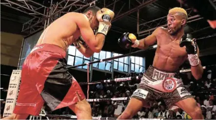  ?? / ALAN EASON ?? Azinga Fuzile dominated Shavkat Rakhimov as he built a healthy lead until he was floored twice in the eighth round of their IBF eliminatio­n clash at the Orient Theatre.