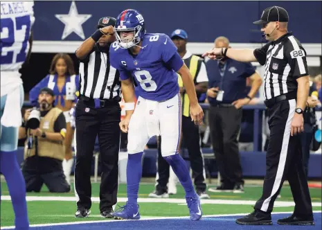  ?? Michael Ainsworth / Associated Press ?? Giants quarterbac­k Daniel Jones attempts to walk off the field after sustaining an injury running the ball in the first half against the Dallas Cowboys in Arlington, Texas, on Sunday.