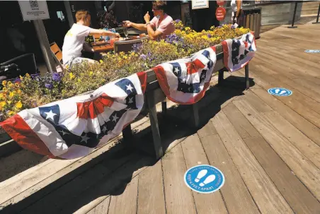  ?? Photos by Scott Strazzante / The Chronicle ?? Pier Market is open for outside dining on Pier 39 in San Francisco, but the country is facing a critical moment in the pandemic.