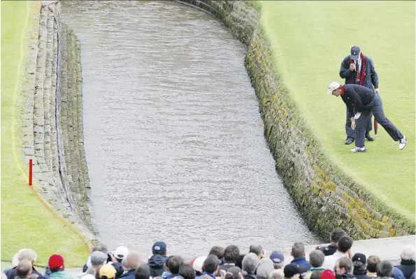  ?? THE ASSOCIATED PRESS ?? Ireland’s Padraig Harrington looks for his ball after hitting his tee shot into the Barry Burn during the final round of the 2007 British Open at Carnoustie. Harrington hit into the winding stream twice on the 18th hole for a double bogey, but still...