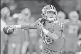  ?? Associated Press ?? Headed to the NFL: Clemson quarterbac­k Trevor Lawrence passes against Ohio State during the first half of the Sugar Bowl NCAA college football game Friday in New Orleans. On Wednesday, Lawrence announced he was entering the NFL draft.