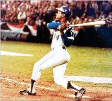  ?? AJC ?? The Braves’ steadily productive Hank Aaron (above, following through on his record 715th home run on April 8, 1974) was the target of a racist backlash from some fans as he climbed the all-time home run list, eventually surpassing Babe Ruth as baseball’s Home Run King.