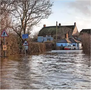  ?? SWNS.com/David Hedges ?? A view of the road into Muchelney in Somerset back in January 2013. The only way to get into the village, it was cut off by flooding when much of the UK endured extreme weather