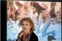  ??  ?? Carolee Schneemann in front of an image of her younger self at the exhibition Carolee Schneemann. Kinetische Malerei in Germany two years ago.