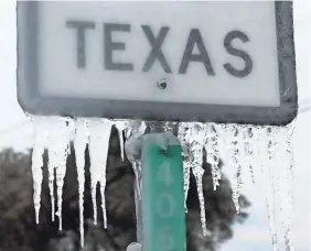  ?? JOE RAEDLE/GETTY IMAGES ?? Icicles hang off the State Highway 195 sign on Feb.18 in Killeen, Texas. Winter storm Uri brought historic cold weather and power outages to Texas.