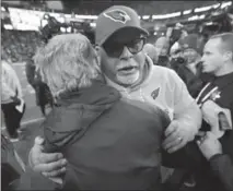  ?? JOHN FROSCHAUER, THE ASSOCIATED PRESS ?? Arizona Cardinals head coach Bruce Arians, front right, hugs Seattle Seahawks head coach Pete Carroll, left, after Sunday’s game.