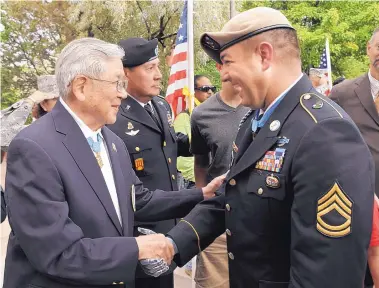  ?? PAT VASQUEZ-CUNNINGHAM/JOURNAL ?? Hiroshi Miyamura greets fellow Medal of Honor recipient Sgt. 1st Class Leroy Petry, a Santa Fe native, in front of the state Capitol in Santa Fe in July 2011 during a ceremony to honor Petry, who had recently received the medal.