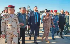  ?? AFP ?? Governor Rakan Al Jabouri (centre) attends the repatriati­on ceremony for members of Iraq’s federal police members who were killed in suspected Daesh attack, at Kirkuk airport.