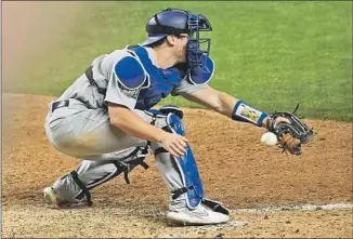  ??  ?? DODGERS CATCHER Will Smith fails to secure the throw to home, allowing Arozarena to score the winning run in a Game 4 meltdown that sets up Clayton Kershaw’s start differentl­y today.