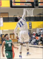  ?? PHOTO BY ROB WORMAN ?? Potomac’s Hakeem Everett (Lackey) dunks home two of his gamehigh 21 as Chesapeake’s Vonnie Watkins (Patuxent) looks on in Friday night’s SMAC senior boys basketball all-star game at North Point High School in Waldorf. Potomac won the contest 82-78.