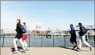  ?? (AP) ?? In this file photo, people run to keep fit along the south bank of the River Thames in London. European Union regulators have said Tuesday Aug. 4, 2020, they’re opening an in-depth investigat­ion into U.S. tech giant Google’s plan to buy fitness tracking device
maker Fitbit.