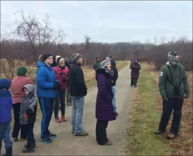  ?? CHAD FELTON — THE NEWS-HERALD ?? Lake Metroparks Interpreti­ve Manager Andy Avram, right, led about a dozen birders through Lake Erie Bluffs in Perry Township on Dec. 29 during the annual Christmas Bird Count. Penitentia­ry Glen Reservatio­n in Kirtland also held a count led by Interpreti­ve Manager Caitliin Ambrose.