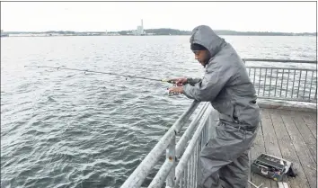  ?? Arnold Gold / Hearst Connecticu­t Media ?? Harold Herring of Hamden fishes in New Haven Harbor from a pier off of South Water Street in New Haven on Oct. 6, 2020.