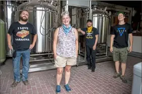  ?? Alexandra Wimley/Post-Gazette ?? Brandon McCarthy, left, Katie Rado, Dave Kuschner and Zach Colton at Trace Brewing, which is set to open in the fall in Bloomfield.