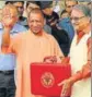  ?? HT PHOTO ?? CM Adityanath and finance minister Rajesh Agarwal outside the state assembly in Lucknow.