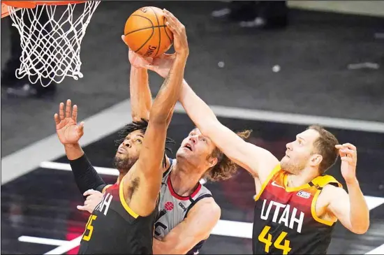  ?? (AP) ?? Washington Wizards center Robin Lopez (center), battle for a rebound against Utah Jazz’s Derrick Favors (15) and Bojan Bogdanovic (44) in the first half during an NBA basketball game in Salt Lake City.