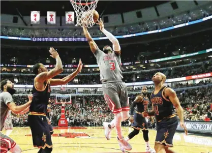  ??  ?? CHICAGO: Dwyane Wade #3 of the Chicago Bulls shoots between Channing Frye #8 (L) and Richard Jefferson #24 of the Cleveland Cavaliers at the United Center on Friday in Chicago, Illinois. — AFP