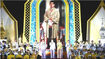  ?? — AFP photo ?? This file photo shows Thai Prime Minister Prayut Chan-O-Cha (centre) leading a ceremony before the portrait of Thai King Maha Vajiralong­korn during celebratio­ns for his 66th birthday near the Grand Palace in Bangkok.