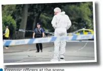  ??  ?? ●●Forensic officers at the scene