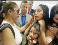  ?? RED HUBER — ORLANDO SENTINEL VIA AP ?? Alejandra Juarez,39, left, says goodbye to her children, Pamela and Estela at the Orlando Internatio­nal Airport on Friday in Orlando, Fla. Juarez, the wife of a former Marine is preparing to self-deport to Mexico in a move that would split up their...