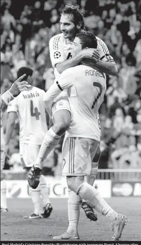  ??  ?? Real Madrid's Cristiano Ronaldo (R) celebrates with teammate Hamit Altontop after scoring a goal against APOEL during their Champions League quarter-final .