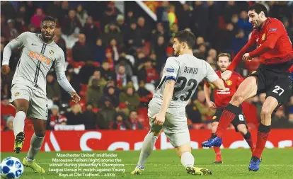  ??  ?? Manchester United’ midfielder Marouane Fellaini (right) scores the winner during yesterday’s Champions League Group H match against YoungBoys at Old Trafford. –