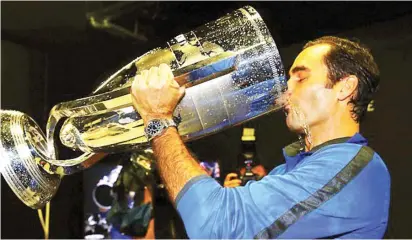  ??  ?? Swiss great Roger Federer drinks out of the Laver Cup following his victory in the Laver Cup over Nick Kyrgios yesterday