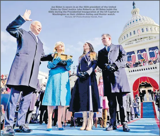  ?? Picture: AP Photo/Andrew Harnik, Pool ?? Joe Biden is sworn in as the 46th president of the United States by Chief Justice John Roberts as Jill Biden holds the Bible during the Presidenti­al Inaugurati­on at the US Capitol in Washington as their children Ashley and Hunter watch.