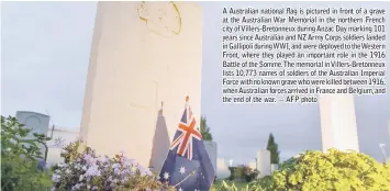  ??  ?? A Australian national flag is pictured in front of a grave at the Australian War Memorial in the northern French city of Villers-Bretonneux during Anzac Day marking 101 years since Australian and NZ Army Corps soldiers landed in Gallipoli during WWI, and were deployed to the Western Front, where they played an important role in the 1916 Battle of the Somme. The memorial in Villers-Bretonneux lists 10,773 names of soldiers of the Australian Imperial Force with no known grave who were killed between 1916, when Australian forces arrived in France and Belgium, and the end of the war. — AFP photo