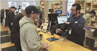  ?? AP PHOTOS ?? HIGH ANXIETY: Nize Nylen, above left, shops for marijuana products in Seattle. Budtender Austin Pitts, above, assists a customer yesterday in Oakland, Calif.