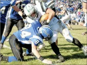  ?? For Montgomery Media / SUSAN KEEN ?? Pennridge’s John Kim rolls over Quakertown’s Dan Frasch during Thursday’s annual Thanksgivi­ng Day game at Alumni Stadium.