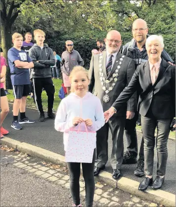  ??  ?? Libby Soutart receives her prize for attending her 25th Brough Park Couch to 5K run.