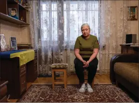  ?? EVGENIY MALOLETKA — THE ASSOCIATED PRESS ?? Iryna Reva, 59, waits for her son Vladyslav at her apartment in Kyiv, Ukraine on Feb. 9. Vladyslav Reva, 25, a Ukrainian soldier went missing during fighting against Russian forces in the Donetsk region July 24, 2022. Iryna’s son-in-law, Oleksandr Dygalo, disappeare­d March 12, 2023 in Donetsk region.