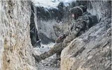  ?? LIBKOS THE ASSOCIATED PRESS ?? Ukrainian soldiers sit in a trench near Bakhmut, Donetsk region, Ukraine, on Saturday.