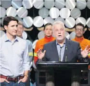  ?? JACQUES BOISSINOT/THE CANADIAN PRESS ?? Prime Minister Justin Trudeau, left, and Quebec Premier Philippe Couillard meet workers during a visit to the Rio Tinto AP60 aluminum plant in Saguenay, Que., Monday.