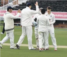  ??  ?? Scarboroug­h all-rounder James Pick is congratula­ted after taking a wicket
