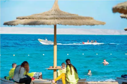  ?? — AFP ?? Tourists spend time at the beach in Egypt’s Red Sea resort of Hurghada.