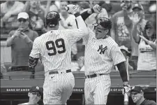  ?? JOHN MINCHILLO/AP PHOTO ?? New York Yankees outfielder Aaron Judge (99) celebrates with Anthony Rizzo (48) after hitting a solo home run off Detroit Tigers starting pitcher Beau Brieske in the first inning of Saturday’s game.