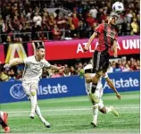  ?? HYOSUB SHIN / HSHIN@AJC.COM ?? United forward Josef Martinez goes high to score Atlanta’s first goal in the first half of the 2-0 MLS Cup victory over the Portland Timbers on Dec. 8.