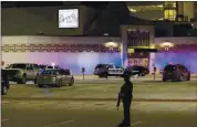  ?? MIKE ROEMER — THE ASSOCIATED PRESS ?? Police stand guard in the parking area outside the Oneida Casino on Sunday morning. Law enforcemen­t officials say a gunman who killed two people was fatally shot by police.