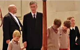  ?? ?? Bowed heads: Jacob Rees-Mogg and his family yesterday