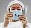  ?? Zhang Yuwei / Associated Press ?? A staff member inspects syringes of COVID-19 vaccine products at a packaging plant in Beijing.