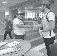  ?? RICK JERVIS, USA TODAY ?? Maria Villena of Mi Familia Vota helps University of Houston student Bob Hall register to vote.