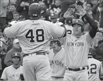  ?? GENE J. PUSKAR/AP PHOTO ?? Chris Carter of the Yankees (48) celebrates with Austin Romine, right, after hitting a pinch-hit, three-run homer in the eighth inning of Saturday’s game against the Pirates at Pittsburgh.