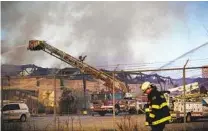  ?? KEVIN HAGEN AP ?? Firefighte­rs battle a blaze at a recycling plant in Passaic, N.J., on Saturday. The blaze is expected to burn for days.